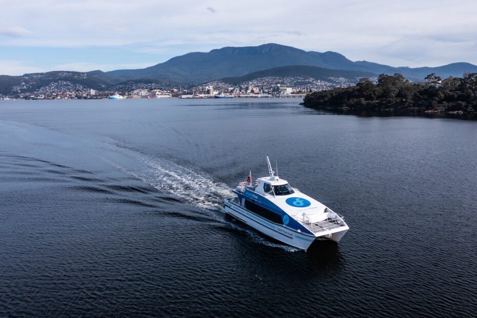 A ferry on the Derwent River with the Hobart city and kunanyi / Mount Wellington in the background.