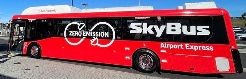 A bright red battery electric Airport Express SkyBus
