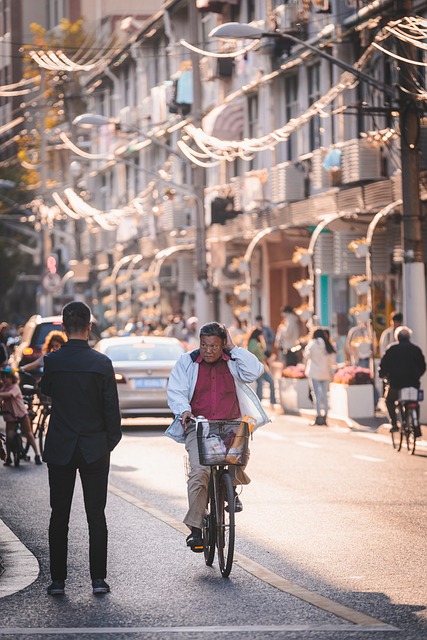 An older man rides a bike down a street