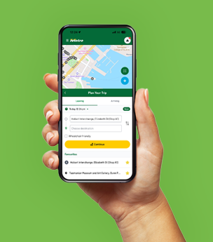 A hand holding a mobile phone displaying the Metro Tas app