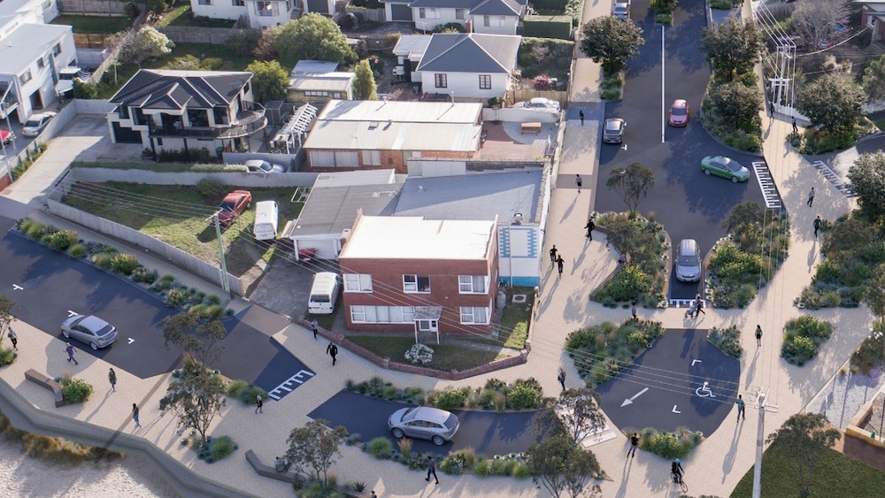 An artist's impression showing a view looking down on the intersection of Queen Street with Victoria Esplanade near Bellerive Beach There are wide footpaths, pedestrian crossings, a disability park, traffic calming features like pinchpoifnts and lots of greenery. There are lots of people walking, a person riding a bike and several cars.