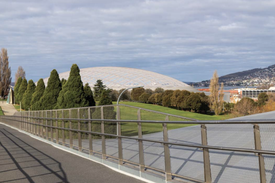 A photo looking east along the Bridge of Remembrance in Hobart. The cenotaph is in the left of the background and an artists impression of the planned Macquarie Point stadium is in the middle of the background.