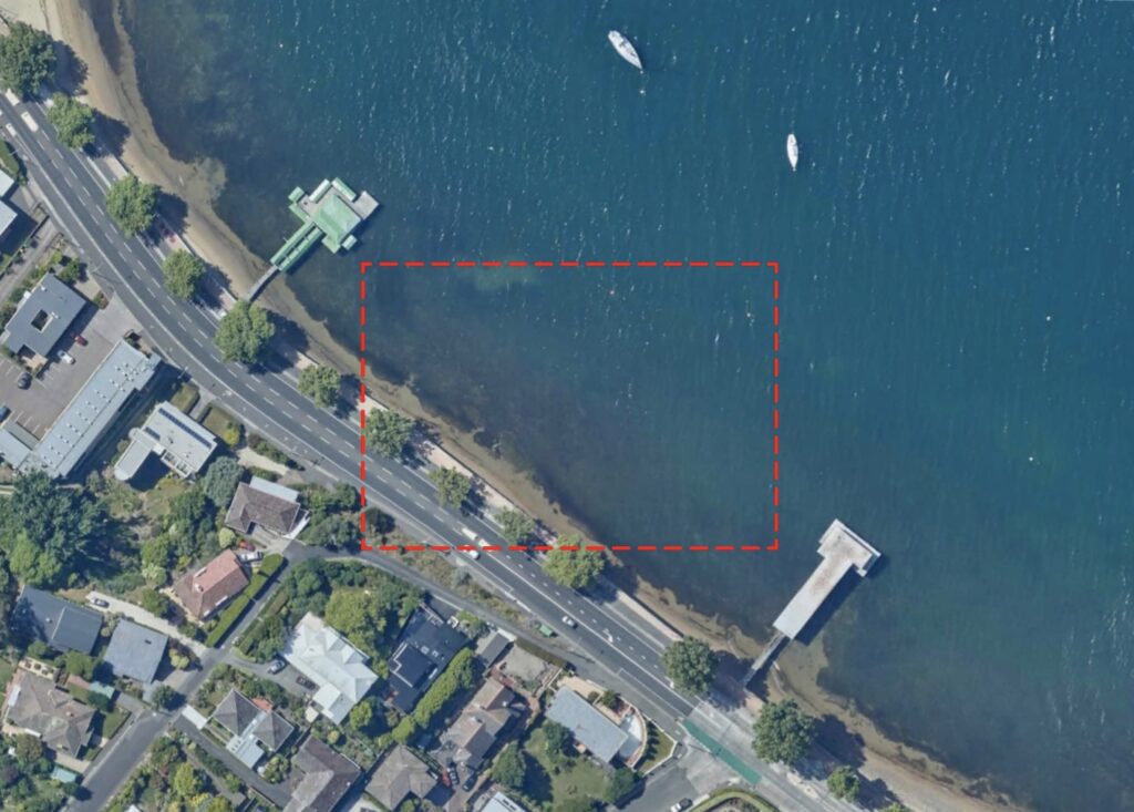 A satellite view of the area between Lords Beach and Red Chapel Beach in Sandy Bay. A red box highlights the area between the two private jetties.